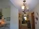 Hallway with elegant light fixture leading to other rooms at 16789 Se 69Th Ln, Ocklawaha, FL 32179