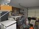 Cluttered garage with storage shelves and a lawnmower at 16789 Se 69Th Ln, Ocklawaha, FL 32179