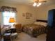 Cozy bedroom featuring a double bed and ample natural light at 16789 Se 69Th Ln, Ocklawaha, FL 32179