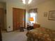 Bedroom with wood closet doors and floral bedding at 16789 Se 69Th Ln, Ocklawaha, FL 32179