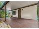Covered front porch with wood flooring and seating at 11531 Se 60Th Ave, Belleview, FL 34420