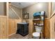 Simple bathroom with vanity, toilet, and wood paneling at 11531 Se 60Th Ave, Belleview, FL 34420