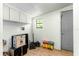 Small storage room with overhead cabinets and a gray door at 11531 Se 60Th Ave, Belleview, FL 34420