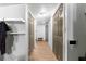 Long hallway with double doors and wood laminate flooring at 11531 Se 60Th Ave, Belleview, FL 34420