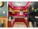 Small kitchen with red walls and wood cabinets at 11531 Se 60Th Ave, Belleview, FL 34420