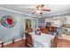 Dining room with hardwood floors, ceiling fan and kitchen access at 612 Fannich Ct, Leesburg, FL 34788