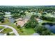 Aerial view showing community with lake and homes at 612 Fannich Ct, Leesburg, FL 34788