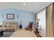 Living room with vaulted ceiling, rocking chair, and hardwood floor at 612 Fannich Ct, Leesburg, FL 34788