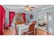 Dining room with hardwood floors, ceiling fan and access to the bedroom at 612 Fannich Ct, Leesburg, FL 34788