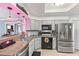 Bright kitchen featuring stainless steel appliances and granite counters at 612 Fannich Ct, Leesburg, FL 34788