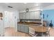 L-shaped kitchen with granite countertops and gray cabinets at 612 Fannich Ct, Leesburg, FL 34788