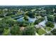 Aerial view of a tranquil neighborhood near a lake at 612 Fannich Ct, Leesburg, FL 34788