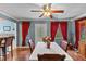 Dining room with hardwood floors, ceiling fan, and a view into the kitchen at 612 Fannich Ct, Leesburg, FL 34788