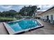 Community outdoor pool with lounge chairs and surrounding landscaping at 612 Fannich Ct, Leesburg, FL 34788