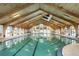 Indoor community swimming pool with high wood ceilings at 612 Fannich Ct, Leesburg, FL 34788