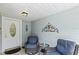 Relaxing front porch with wicker chairs and small table at 612 Fannich Ct, Leesburg, FL 34788