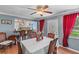 Bright dining room with hardwood floors, ceiling fan, and kitchen view at 612 Fannich Ct, Leesburg, FL 34788