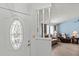 Entryway with an oval window and view into the living room at 612 Fannich Ct, Leesburg, FL 34788