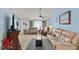 Living area with vaulted ceiling, neutral decor, and comfy seating at 612 Fannich Ct, Leesburg, FL 34788