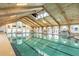 Inviting indoor pool with high ceilings and natural light at 612 Fannich Ct, Leesburg, FL 34788