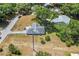 Aerial view of a single-Gathering home on a large lot with mature trees at 612 Fannich Ct, Leesburg, FL 34788