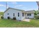 Well-maintained light gray house with a side patio at 612 Fannich Ct, Leesburg, FL 34788