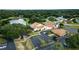 Aerial view of community featuring a clubhouse, pool, and lush landscaping at 612 Fannich Ct, Leesburg, FL 34788