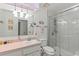 Updated bathroom with vanity, large mirror, and walk-in shower at 612 Fannich Ct, Leesburg, FL 34788