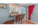 Kitchen features a breakfast bar with granite countertop and pendant lighting at 612 Fannich Ct, Leesburg, FL 34788