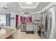 Modern kitchen with stainless steel appliances and granite countertops at 612 Fannich Ct, Leesburg, FL 34788
