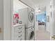 Convenient laundry room with washer, dryer, and storage at 612 Fannich Ct, Leesburg, FL 34788