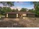 Charming ranch-style home with a green exterior and well-maintained landscaping at 8975 Sw 202Nd Avenue Rd, Dunnellon, FL 34431