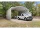 Carport shelters a truck and boat, providing ample covered parking at 8975 Sw 202Nd Avenue Rd, Dunnellon, FL 34431