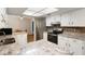 Bright kitchen with granite countertops, stainless steel appliances, and white cabinets at 8975 Sw 202Nd Avenue Rd, Dunnellon, FL 34431