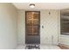 Front door with a decorative screen and welcome mat at 8975 Sw 202Nd Avenue Rd, Dunnellon, FL 34431