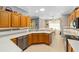 Well-equipped kitchen with oak cabinets, granite countertops, and breakfast bar at 8678 Sw 83Rd Cir, Ocala, FL 34481