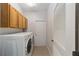 Laundry room with washer, dryer, cabinets, and exterior access at 8678 Sw 83Rd Cir, Ocala, FL 34481
