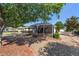 Screened patio with a pebble stone backyard and mature trees at 8678 Sw 83Rd Cir, Ocala, FL 34481