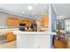 Well-equipped kitchen with oak cabinets, granite countertops, and breakfast bar at 8678 Sw 83Rd Cir, Ocala, FL 34481