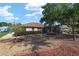 Landscaped backyard with screened patio and gravel at 8678 Sw 83Rd Cir, Ocala, FL 34481