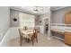 Bright breakfast nook with a floral table and four chairs, adjacent to the kitchen at 8678 Sw 83Rd Cir, Ocala, FL 34481
