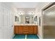 Bathroom with double sinks, a large mirror, and a walk-in shower at 8678 Sw 83Rd Cir, Ocala, FL 34481
