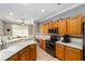 Well-equipped kitchen with oak cabinets, granite countertops, and breakfast bar at 8678 Sw 83Rd Cir, Ocala, FL 34481
