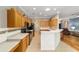 Well-equipped kitchen with oak cabinets, granite countertops, and breakfast bar at 8678 Sw 83Rd Cir, Ocala, FL 34481
