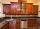 Modern kitchen with granite countertops and dark wood cabinets at 1719 Sw 27Th Pl, Ocala, FL 34471