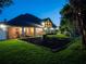 Spacious backyard with a fire pit and screened porch at night at 1719 Sw 27Th Pl, Ocala, FL 34471