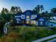 Two-story house with gray siding, stone accents, and a landscaped yard at 1719 Sw 27Th Pl, Ocala, FL 34471