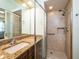 Bathroom with walk-in shower and granite vanity at 1719 Sw 27Th Pl, Ocala, FL 34471