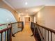 Upstairs hallway with wood railing and carpet flooring at 1719 Sw 27Th Pl, Ocala, FL 34471