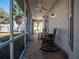Relaxing screened porch with rocking chairs and tiled floor at 1719 Sw 27Th Pl, Ocala, FL 34471